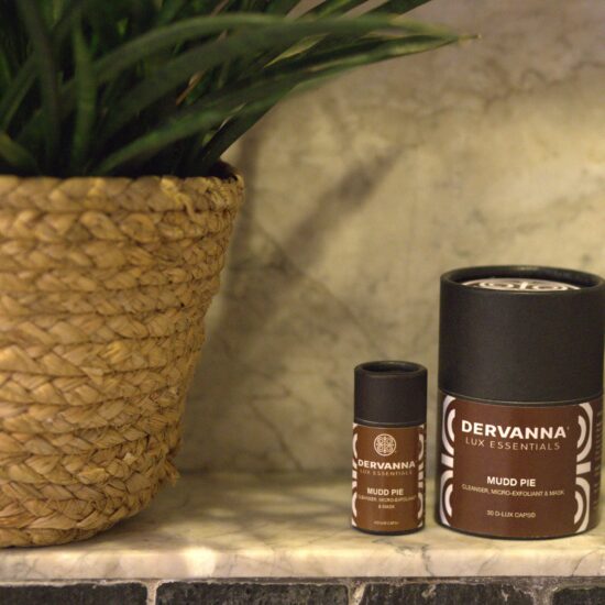 Skincare products beside a woven basket plant.